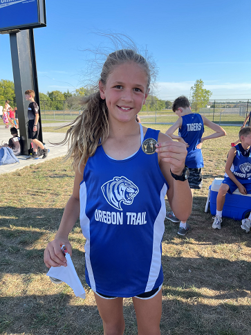 a runner holds her medal